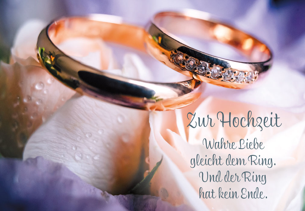 Hochzeit - goldene Ringe auf Blumen